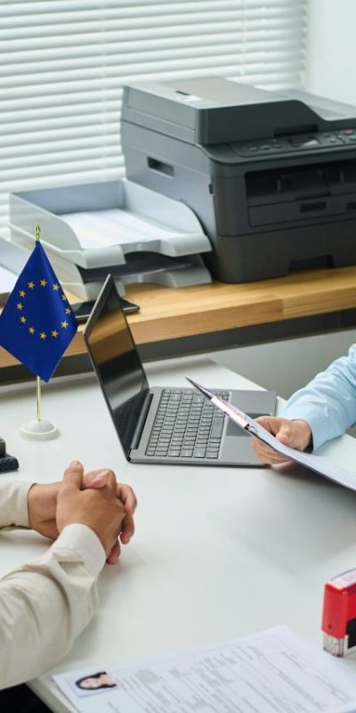 specialist-of-visa-service-asking-questions-to-man