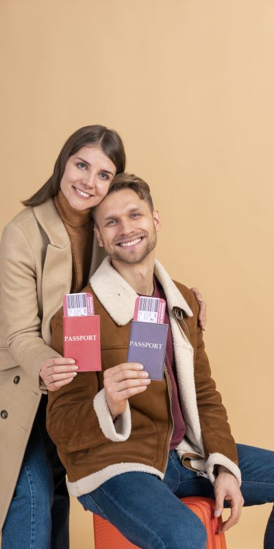 young-couple-posing-together-with-passport-plane-tickets